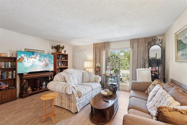 living room featuring a textured ceiling and light tile patterned flooring