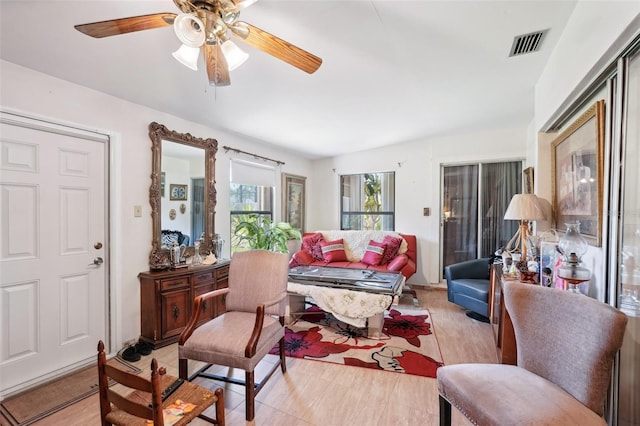 interior space featuring visible vents and ceiling fan