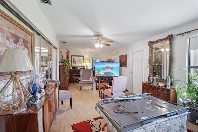 interior space with visible vents, a ceiling fan, and light wood-style floors