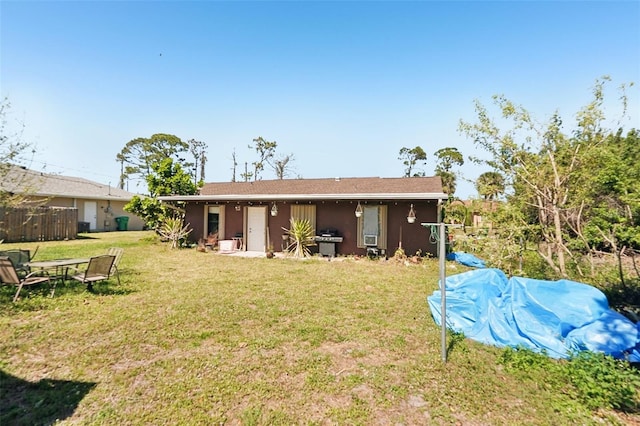 rear view of house featuring a lawn