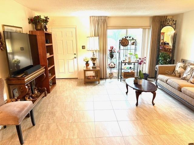 2678 Rock Creek Dr, Port Charlotte, FL 33948 - living room with light tile patterned floors