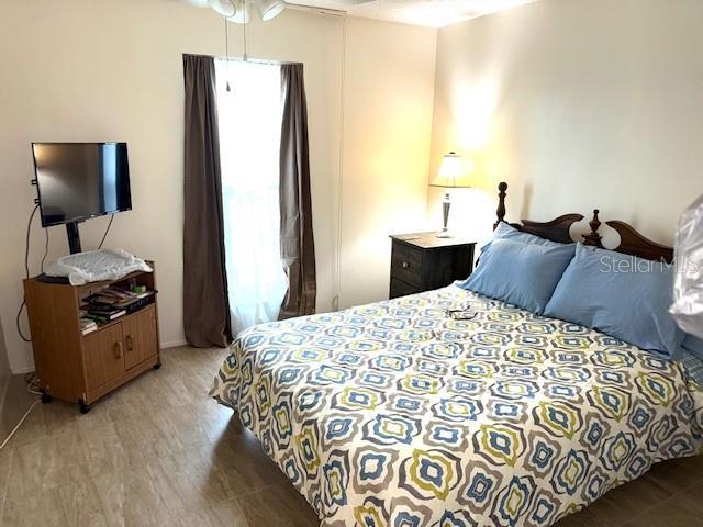2678 Rock Creek Dr, Port Charlotte, FL 33948 - bedroom featuring light wood finished floors and multiple windows
