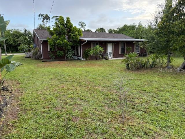 2678 Rock Creek Dr, Port Charlotte, FL 33948 - view of front of home with a front lawn