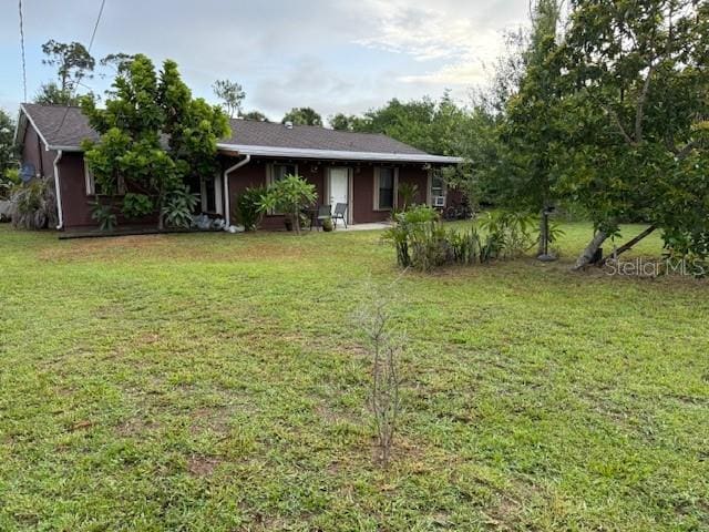 2678 Rock Creek Dr, Port Charlotte, FL 33948 - view of front of property with a front yard