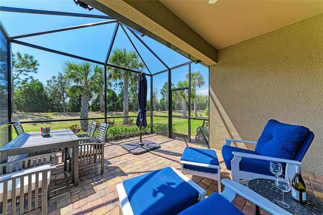 view of patio with glass enclosure, an outdoor hangout area, and outdoor dining area