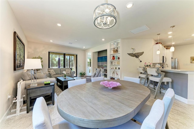 dining room with recessed lighting, baseboards, and a chandelier