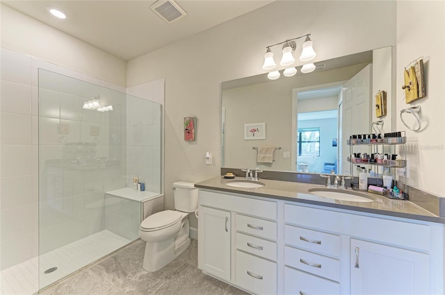 full bath featuring walk in shower, toilet, visible vents, and a sink