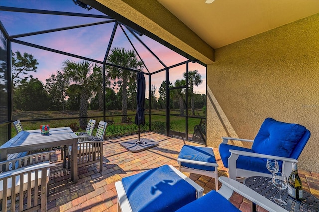 patio terrace at dusk with glass enclosure and outdoor dining area