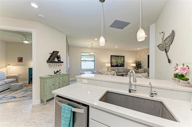 kitchen featuring stainless steel dishwasher, visible vents, open floor plan, and a sink