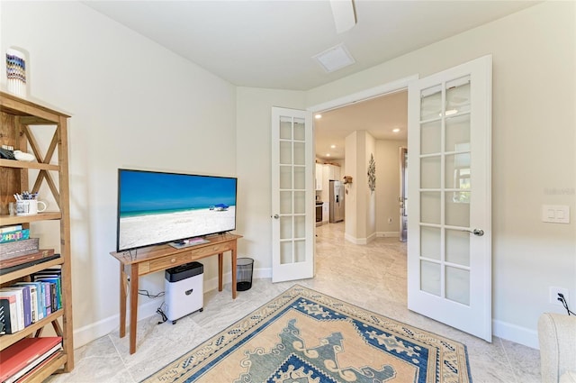 sitting room featuring french doors and baseboards