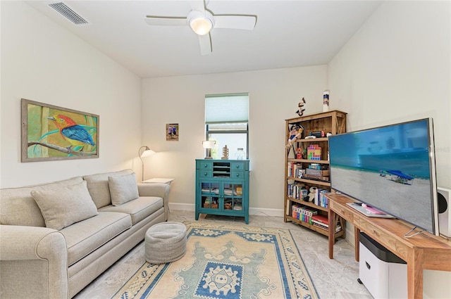 living area with visible vents, baseboards, and ceiling fan