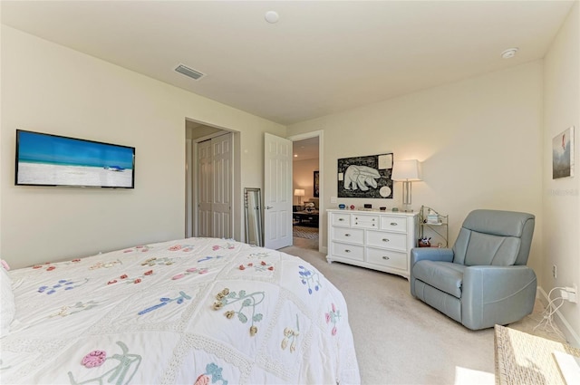 bedroom with visible vents and light colored carpet