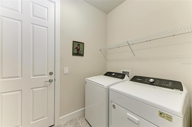 laundry area featuring laundry area, separate washer and dryer, and baseboards