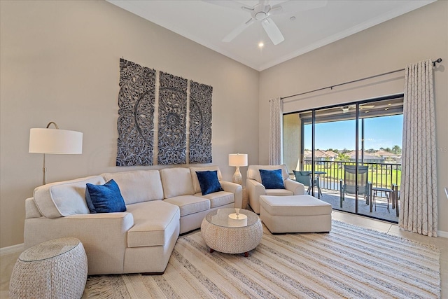 living area with baseboards, ceiling fan, and crown molding