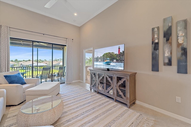 living room featuring baseboards, ornamental molding, a ceiling fan, and tile patterned flooring