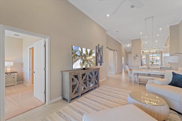 living room featuring baseboards, light colored carpet, ornamental molding, light tile patterned floors, and high vaulted ceiling