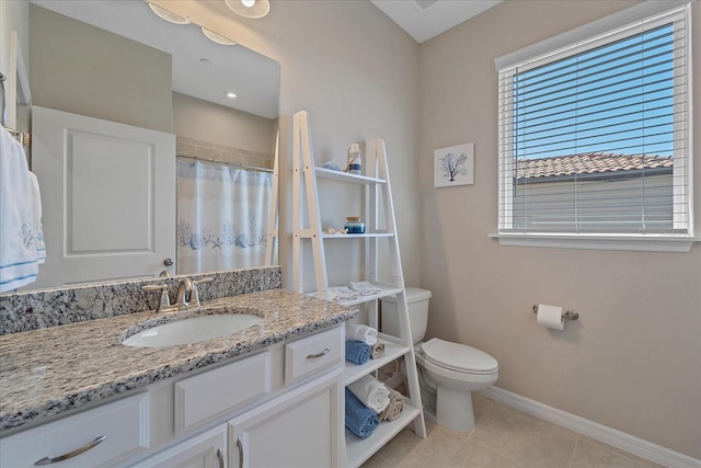 full bathroom featuring tile patterned flooring, toilet, vanity, and baseboards