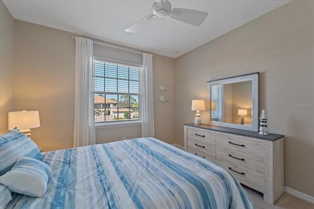 bedroom featuring baseboards, a ceiling fan, and carpet flooring