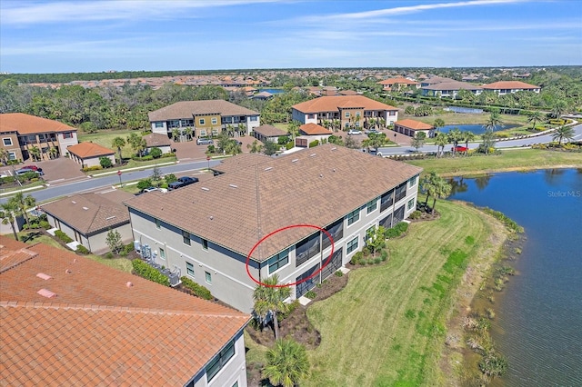 bird's eye view with a residential view and a water view