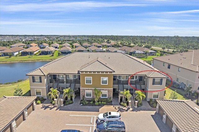 birds eye view of property featuring a residential view and a water view