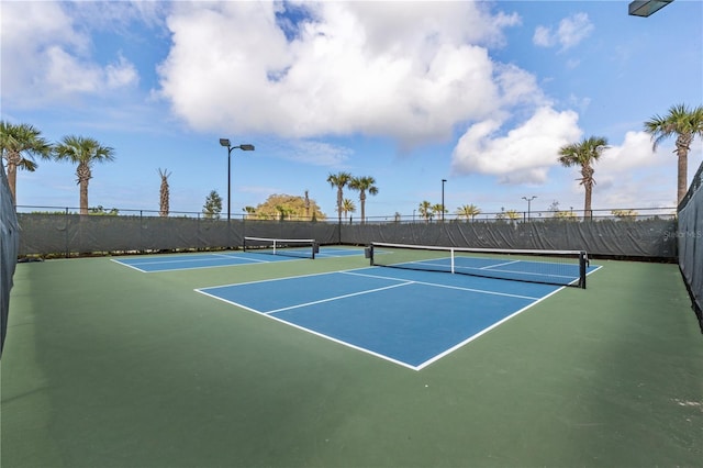 view of tennis court with fence