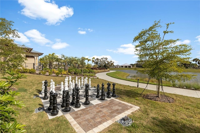 surrounding community featuring a yard and a water view