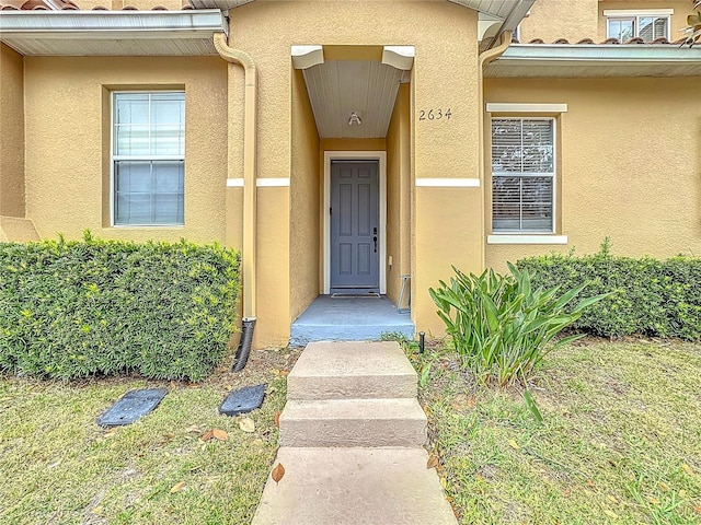 property entrance with stucco siding