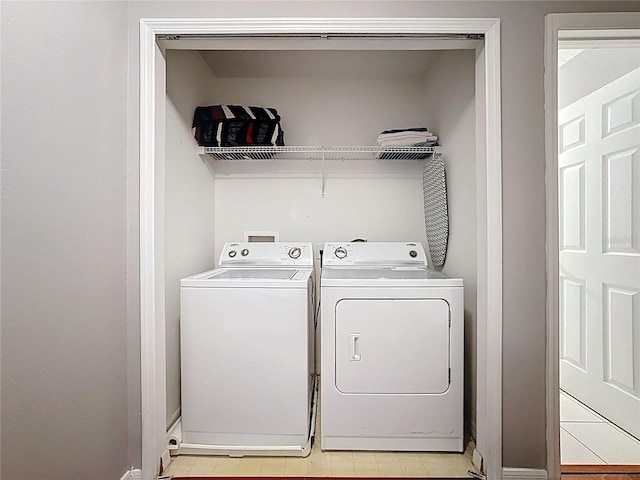 laundry room with washing machine and clothes dryer