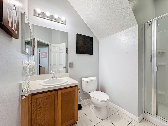 bathroom featuring vanity, a shower stall, vaulted ceiling, tile patterned floors, and toilet