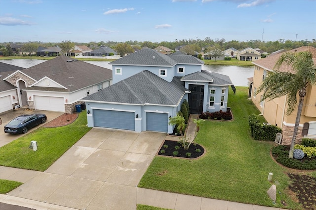 view of front of property featuring a front lawn, a residential view, roof with shingles, driveway, and an attached garage