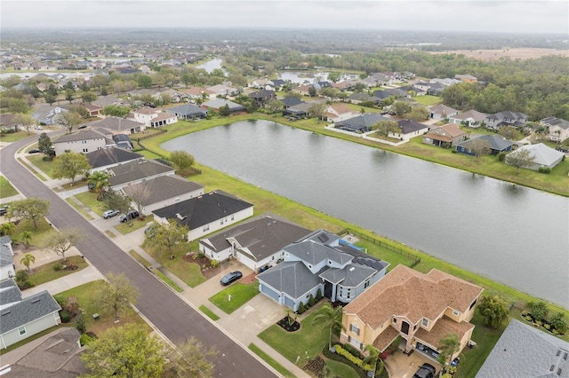 drone / aerial view featuring a residential view and a water view