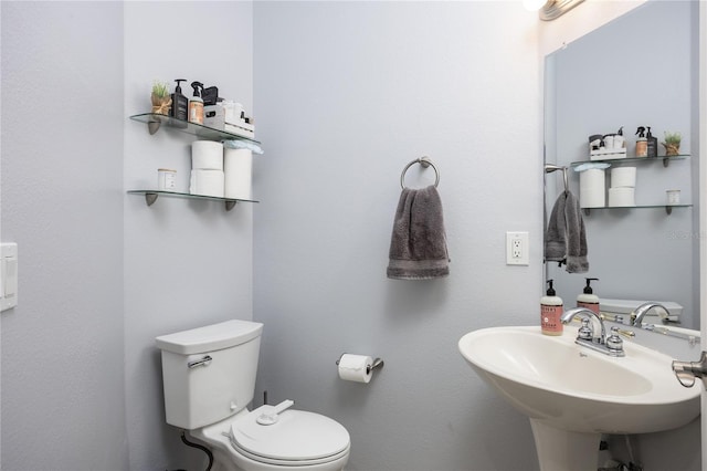 half bathroom featuring a sink and toilet