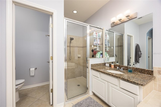 bathroom featuring visible vents, toilet, a shower stall, tile patterned flooring, and vanity