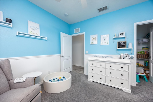 interior space with visible vents, a wainscoted wall, and vanity