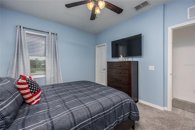 carpeted bedroom with a ceiling fan, baseboards, and visible vents