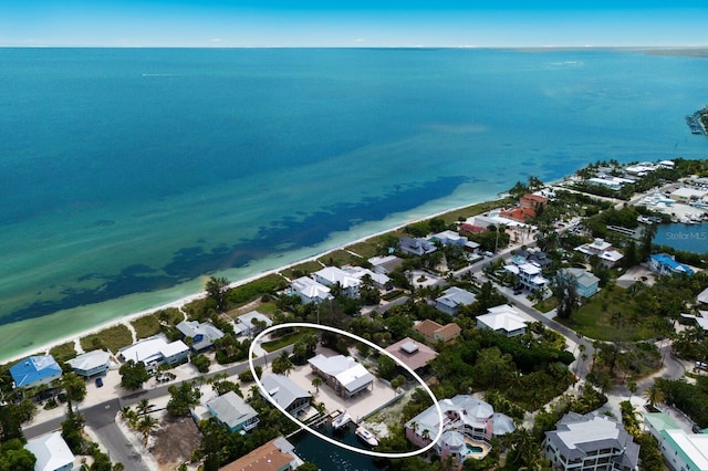 drone / aerial view featuring a residential view and a water view