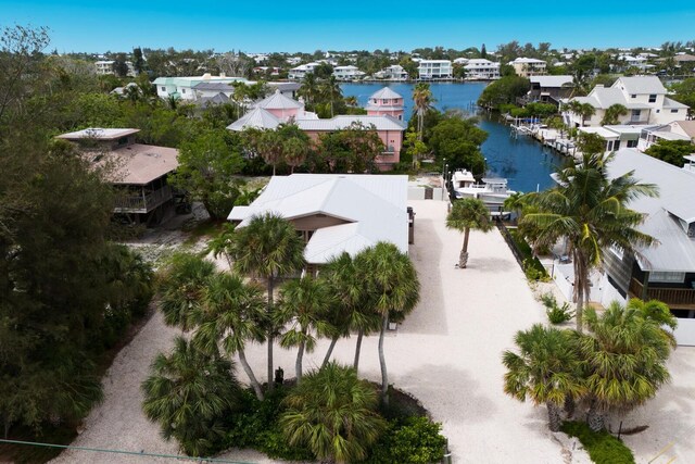 drone / aerial view with a residential view and a water view