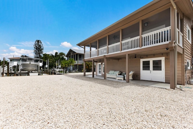 back of house featuring a patio area, a sunroom, and ceiling fan