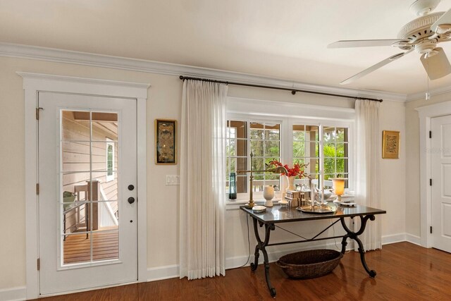 entryway featuring baseboards, a ceiling fan, wood finished floors, and crown molding