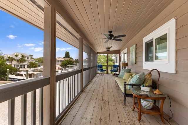 wooden deck with a residential view and a ceiling fan