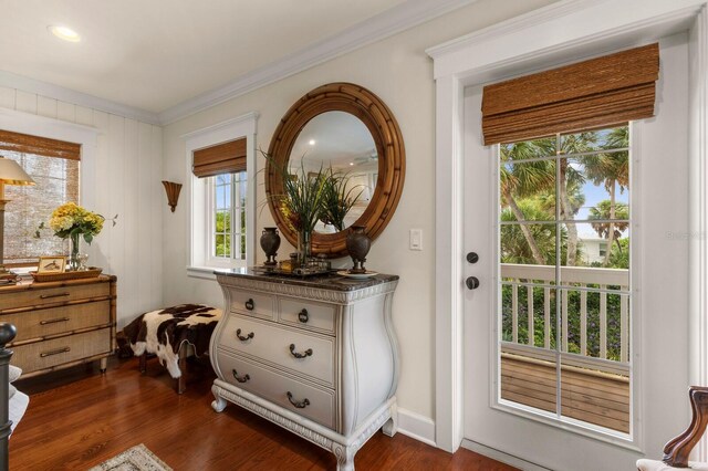 interior space featuring baseboards, dark wood-type flooring, and ornamental molding