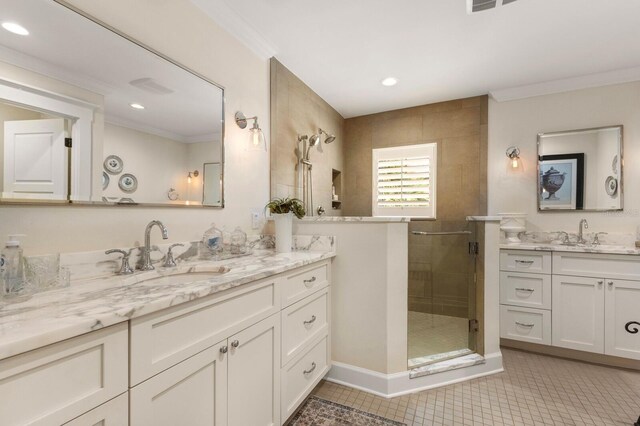 full bathroom with a shower stall, ornamental molding, tile patterned floors, and a sink