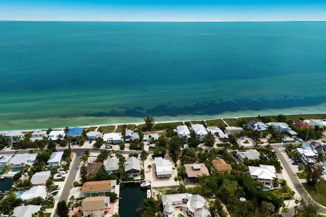 drone / aerial view with a residential view and a water view