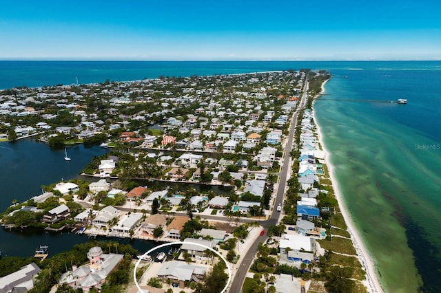 birds eye view of property with a residential view, a water view, and a beach view