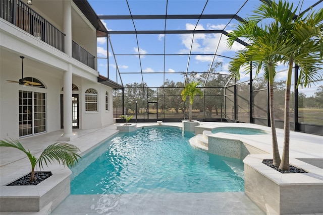 view of pool featuring a patio, a lanai, a ceiling fan, and a pool with connected hot tub