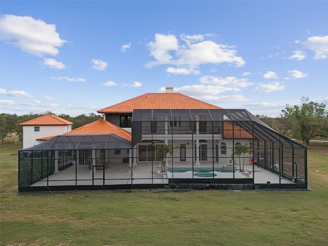 pool featuring glass enclosure, a yard, and a patio area