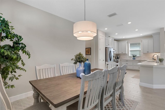 dining area with visible vents, recessed lighting, light wood-style floors, and baseboards