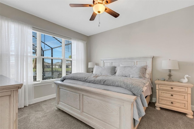 bedroom with light colored carpet, baseboards, and ceiling fan