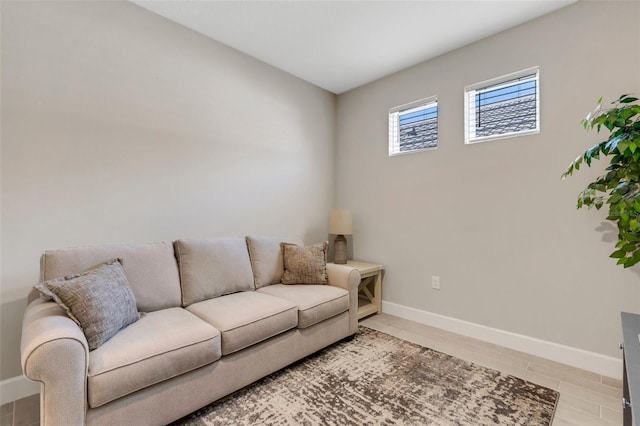 living area featuring light wood-type flooring and baseboards