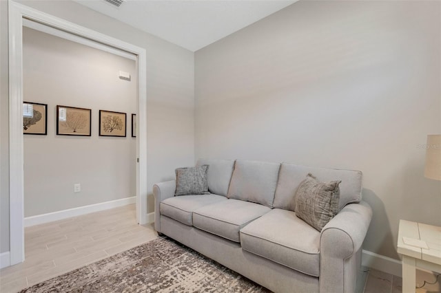 living room with baseboards and light wood finished floors